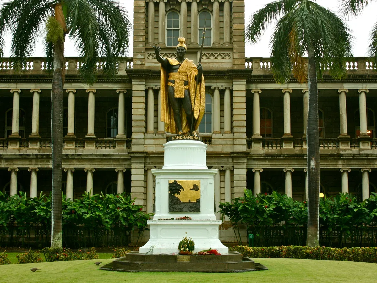 The gilded King Kamehameha statue in downtown Honolulu, in front of Aliiolani Hale, a stop on most city combinations, seen on Pearl Harbor tours from Honolulu